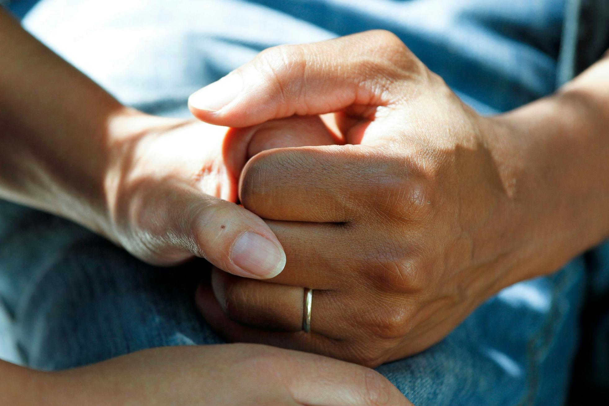 people holding hands for comfort
