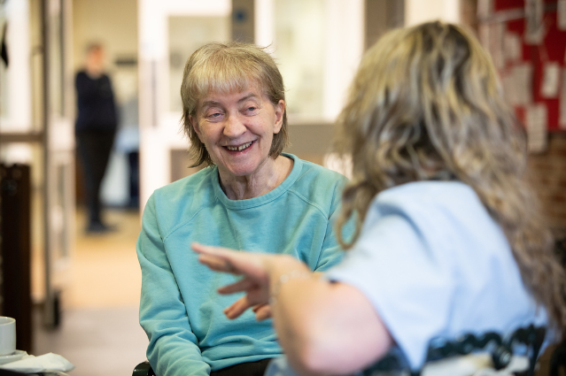 lady wearing green jumper smiling